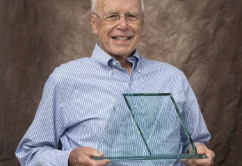 Darle Shouse holding his Red Triangle award