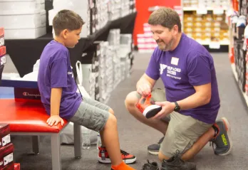 Boy trying on new shoes