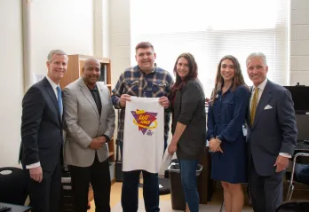 Teenager holding up a tshirt