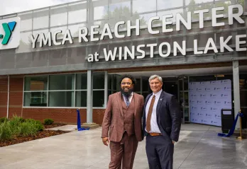 kenneth pettigrew and darryl head infront of newly opened YMCA REACH Center at Winston Lake