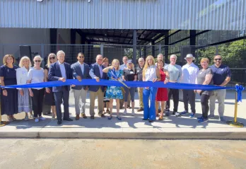 Debbie Jennings cutting ribbon infront of new airnasium