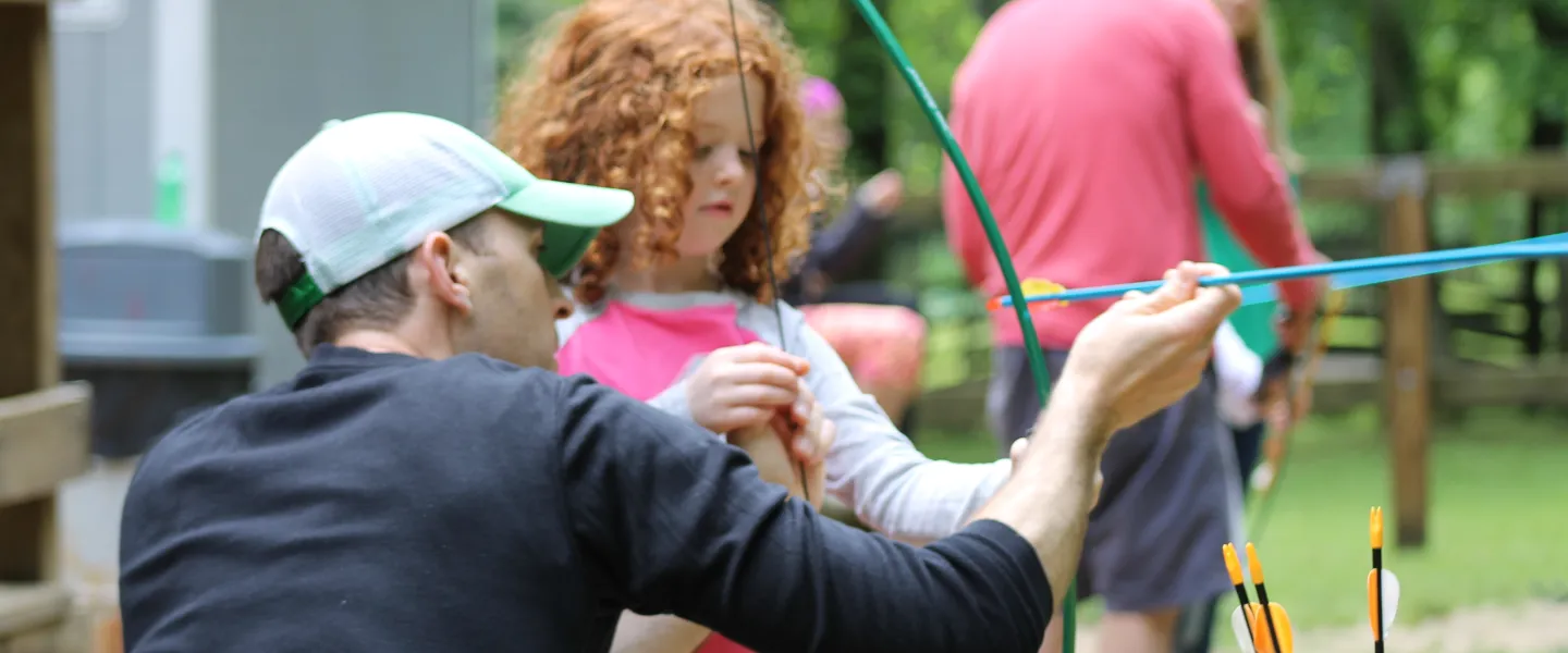 Dad and daughter doing archery