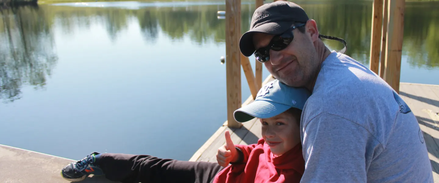 Father and son sitting on a dock