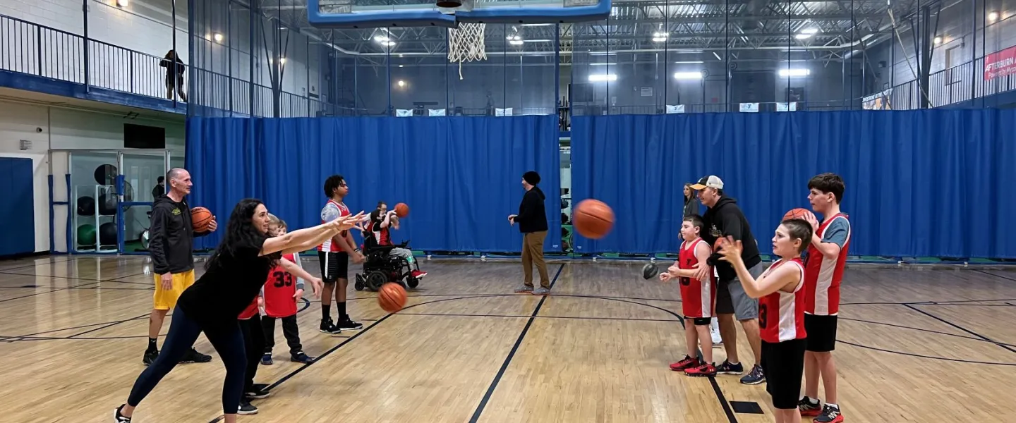 Kids lining up to pass a basketball