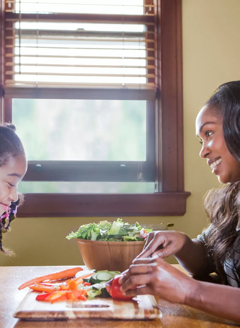 Mom and daughter making a salad