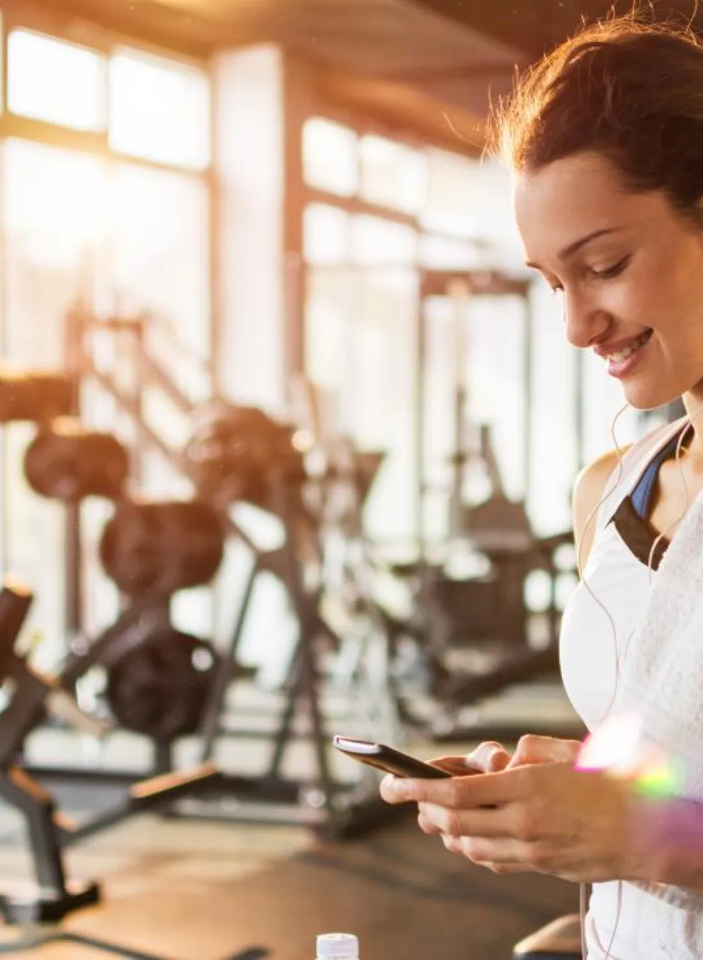 Woman looking at her phone at the gym