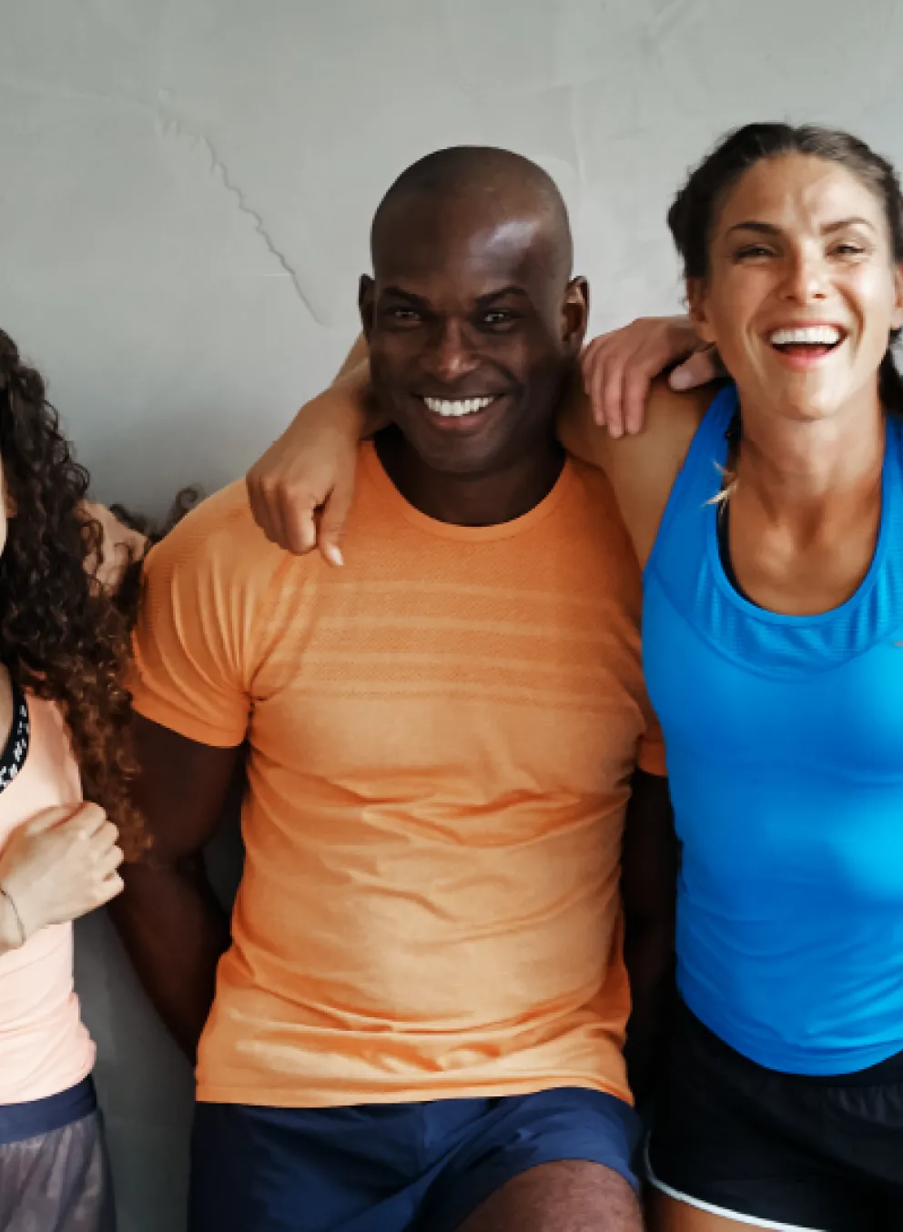 People smiling with their arms around each other