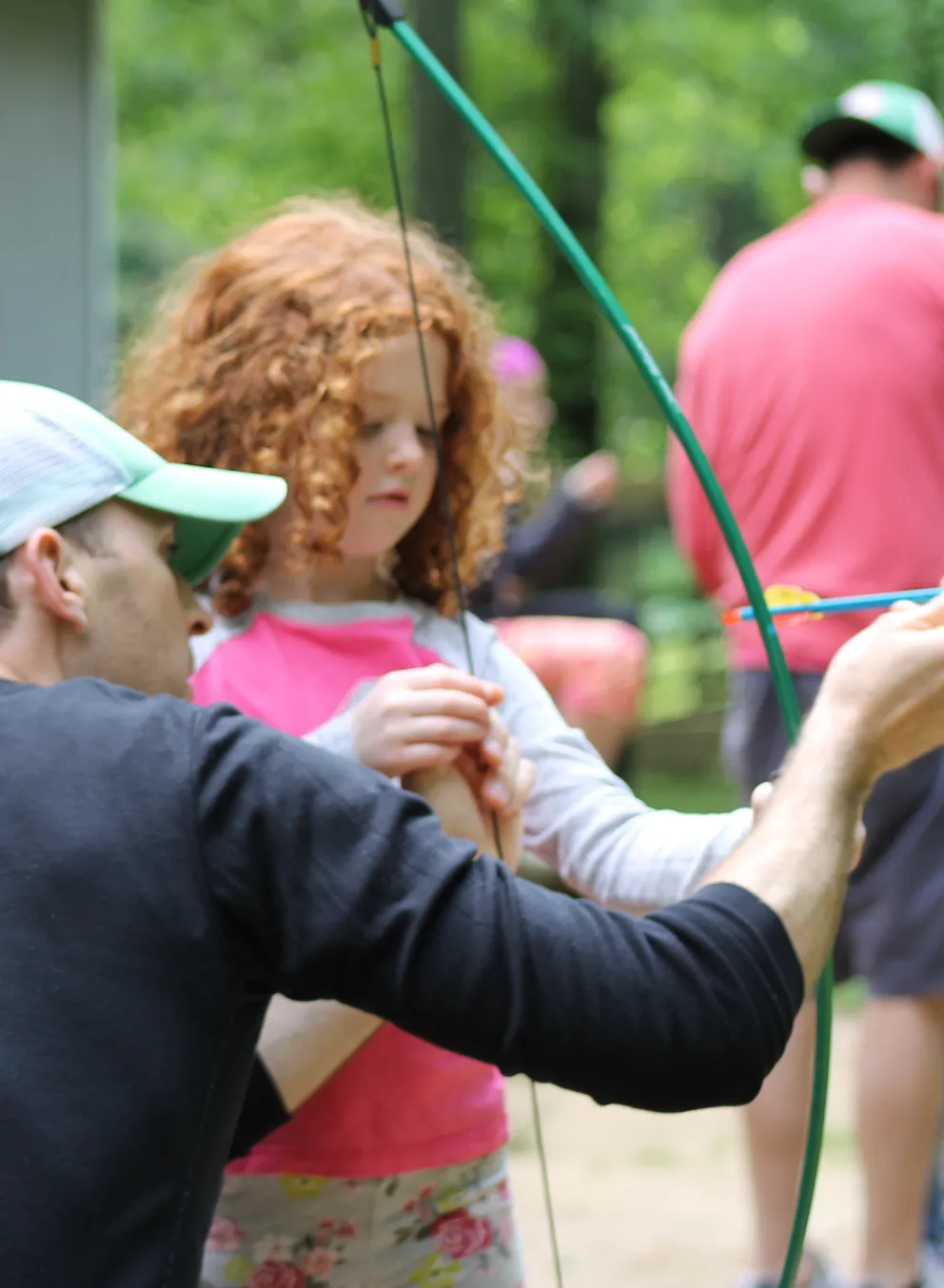 Dad and daughter doing archery