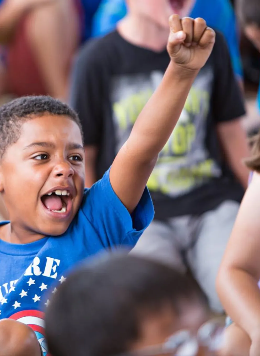Child happy with his arm in the air