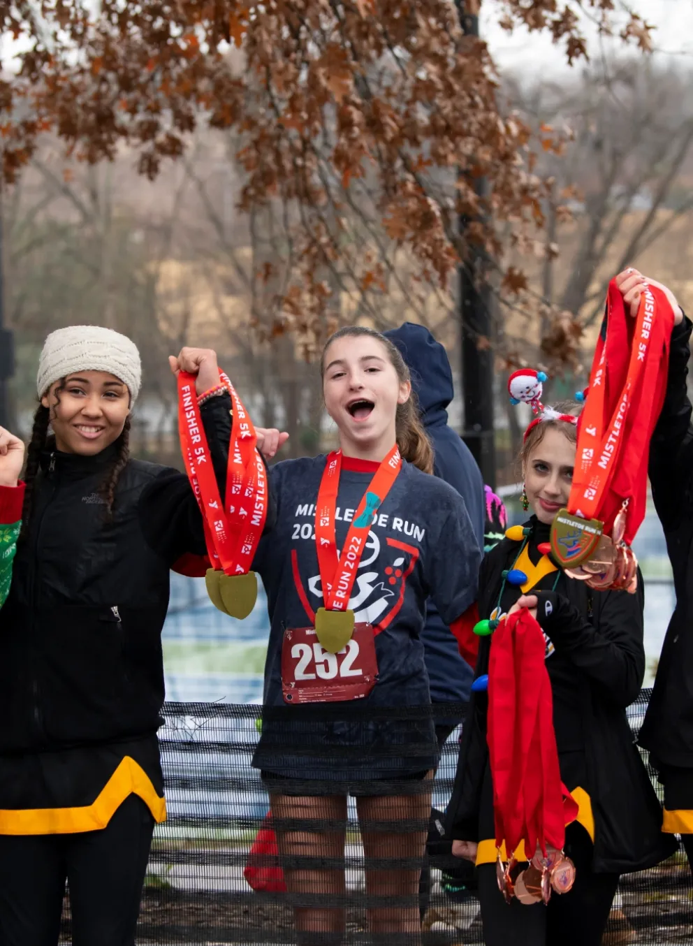 Girls holding up race medals