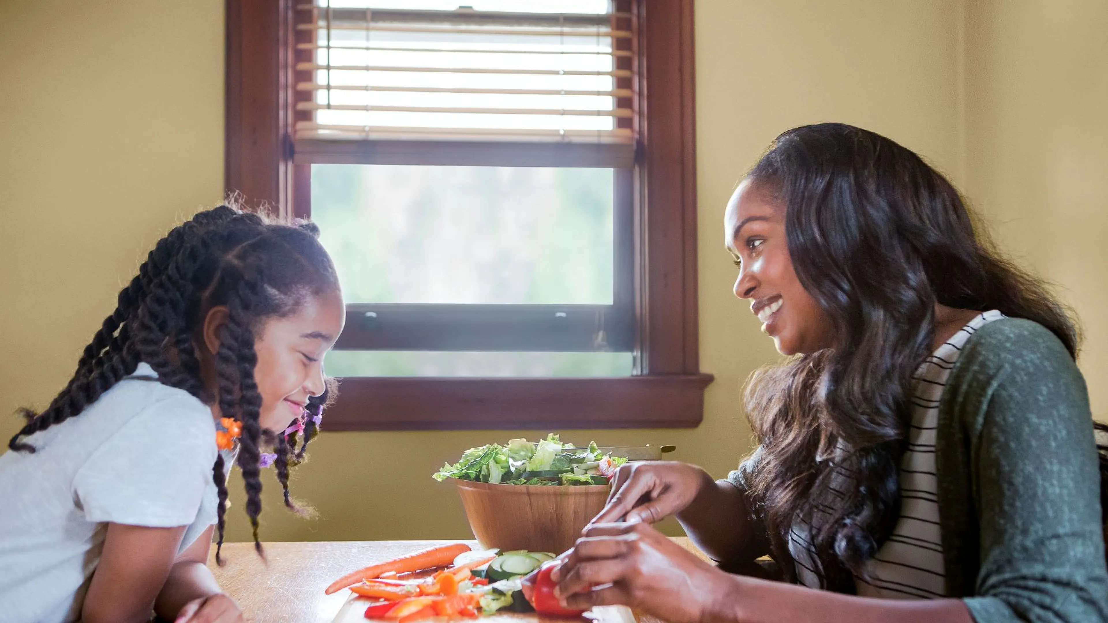 Mom and daughter making a salad