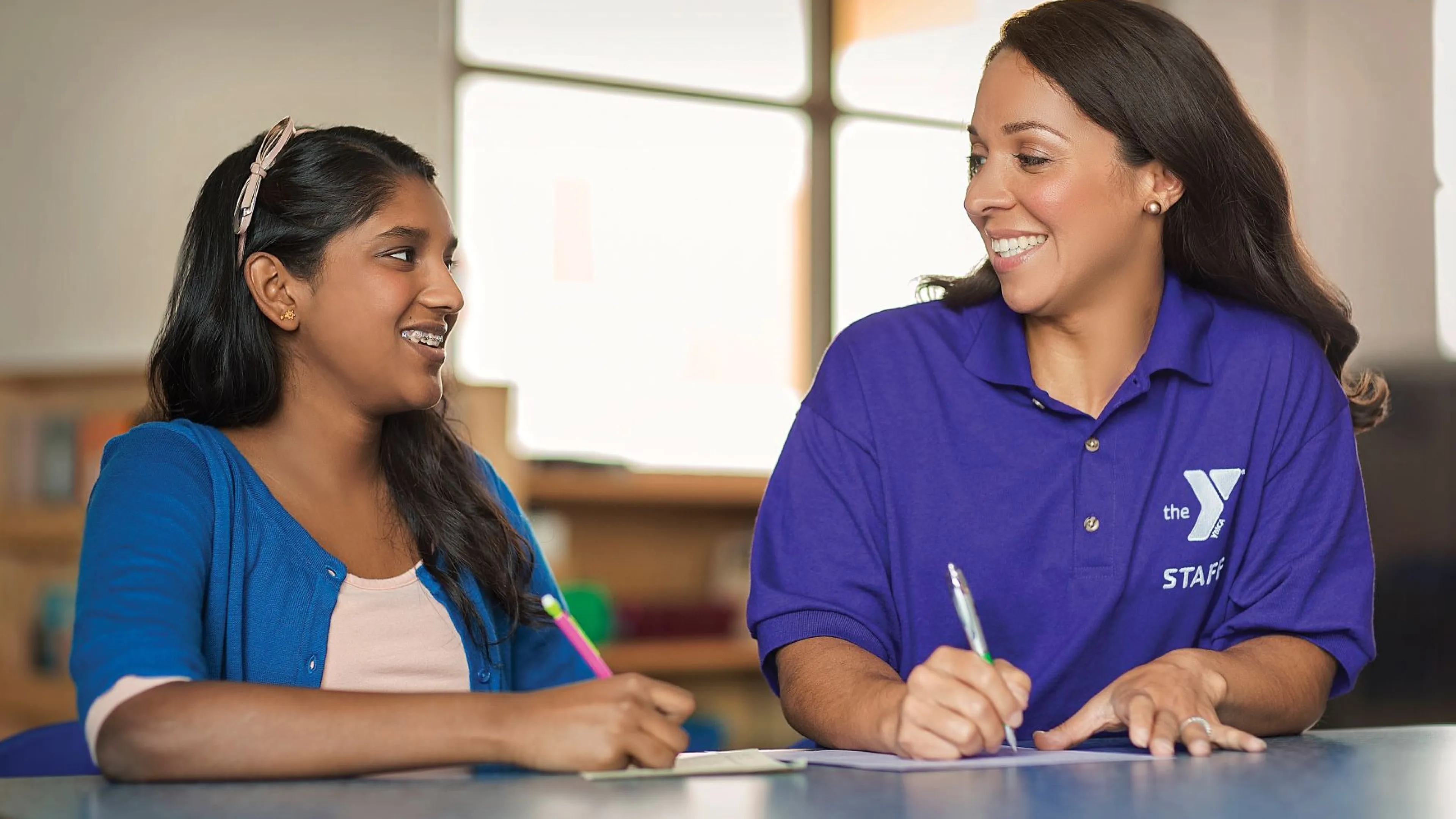 YMCA employee teaching student
