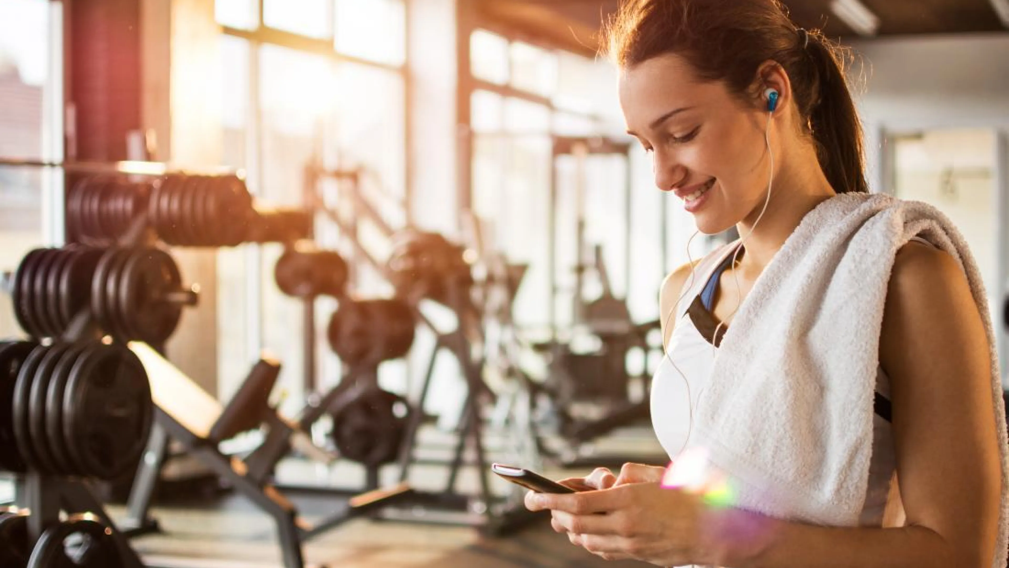 Woman looking at her phone at the gym