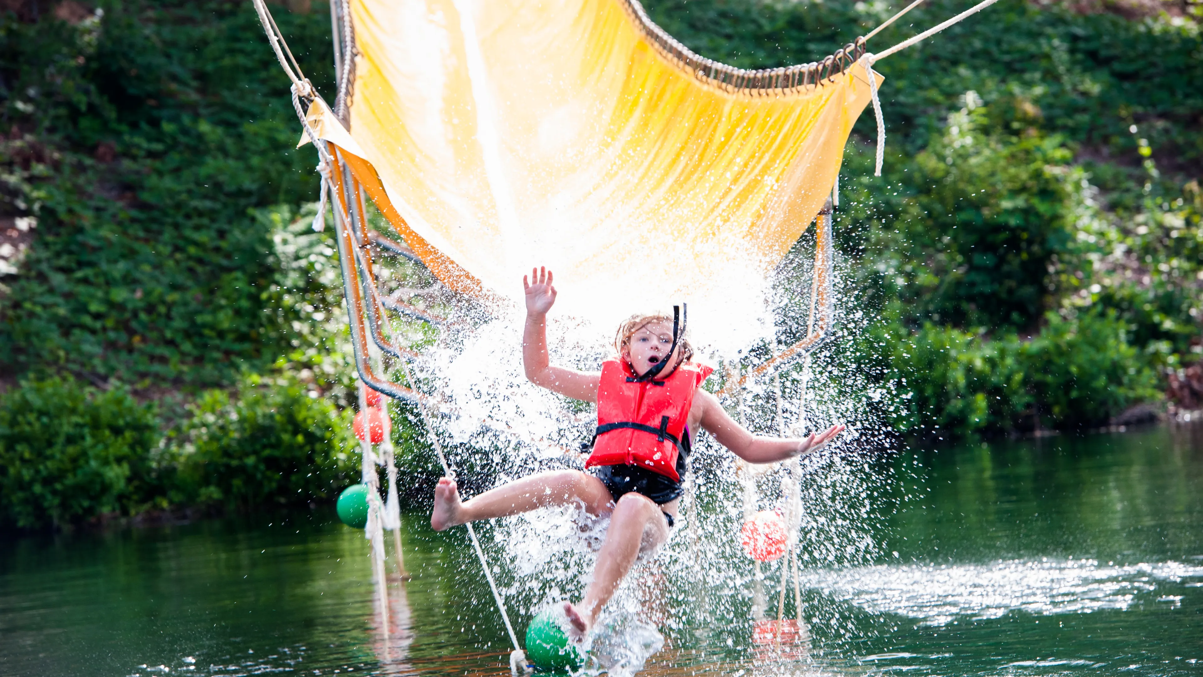 Child on Camp Hanes water zip line