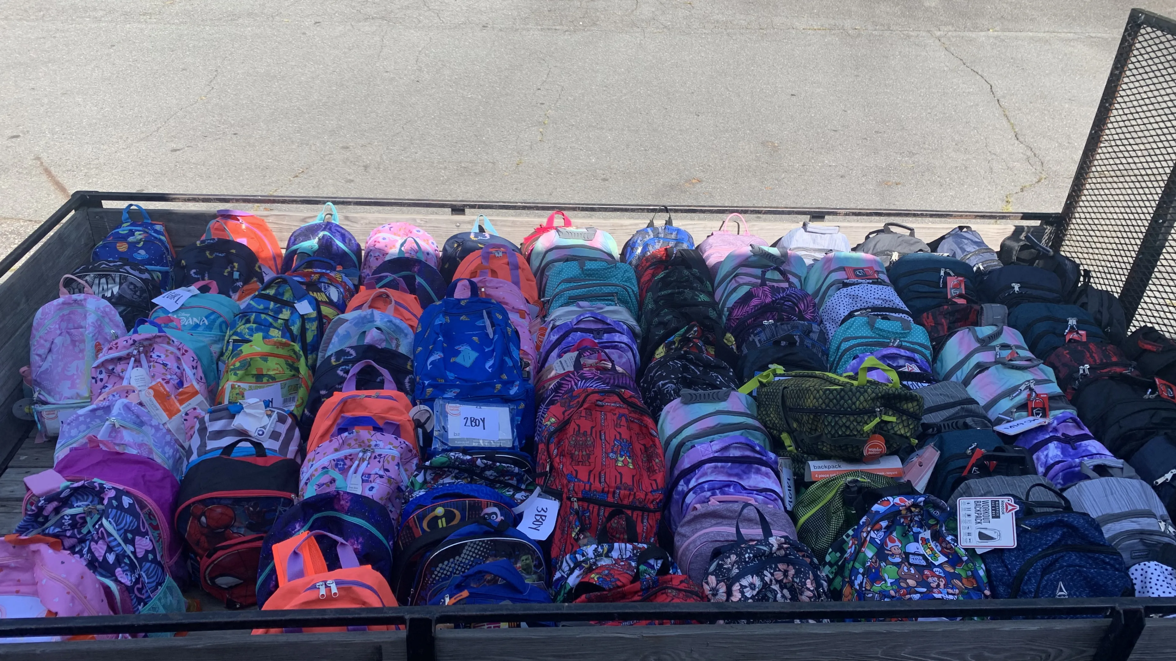 A truck bed full of backpacks