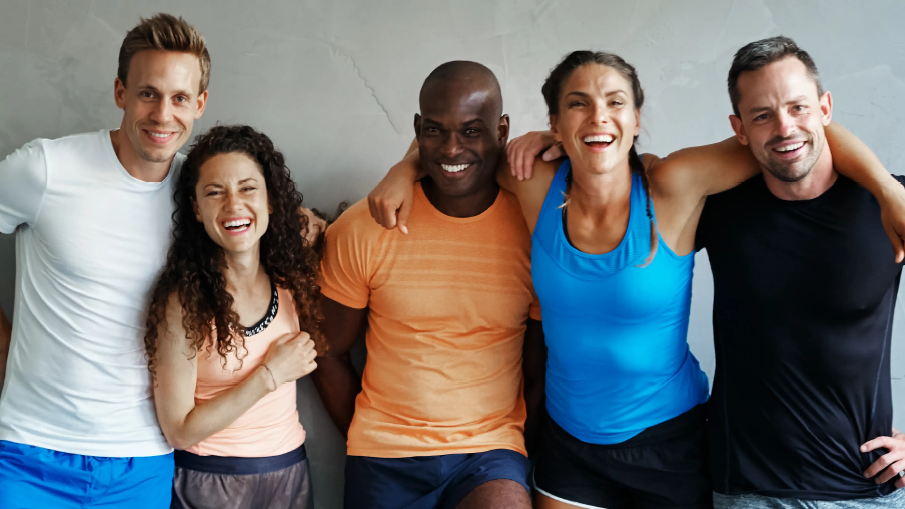 People smiling with their arms around each other