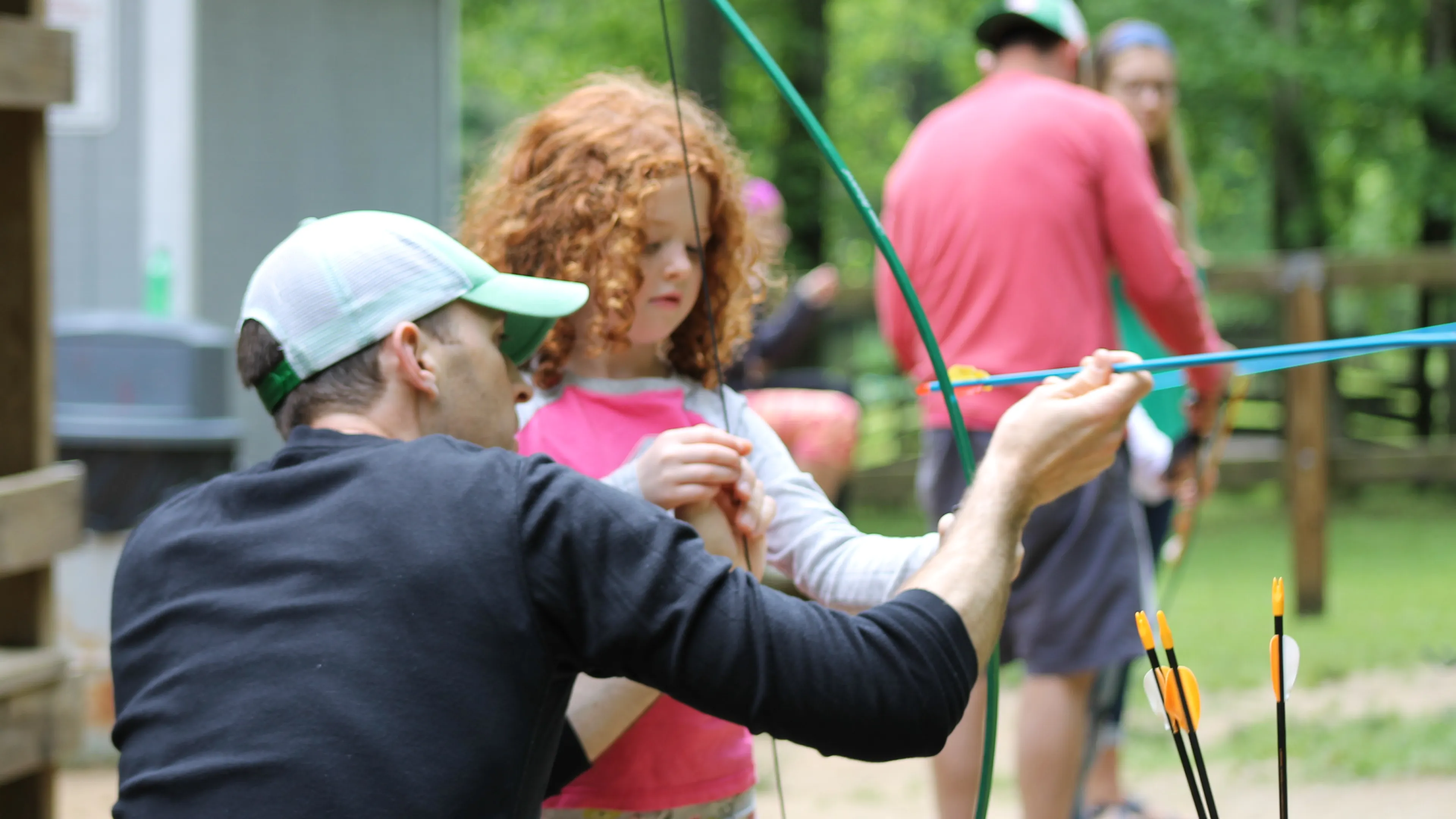 Dad and daughter doing archery