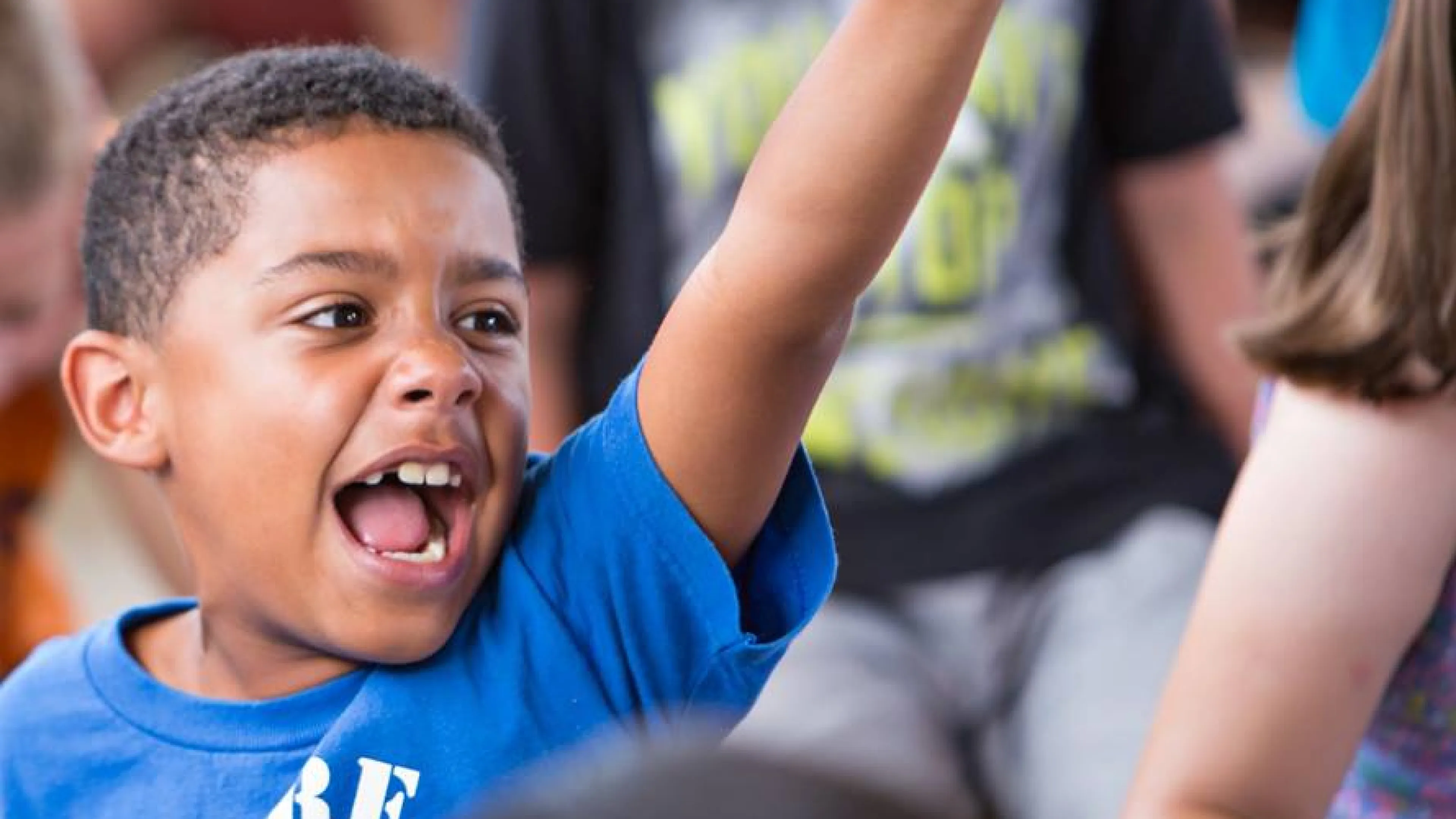 Child happy with his arm in the air