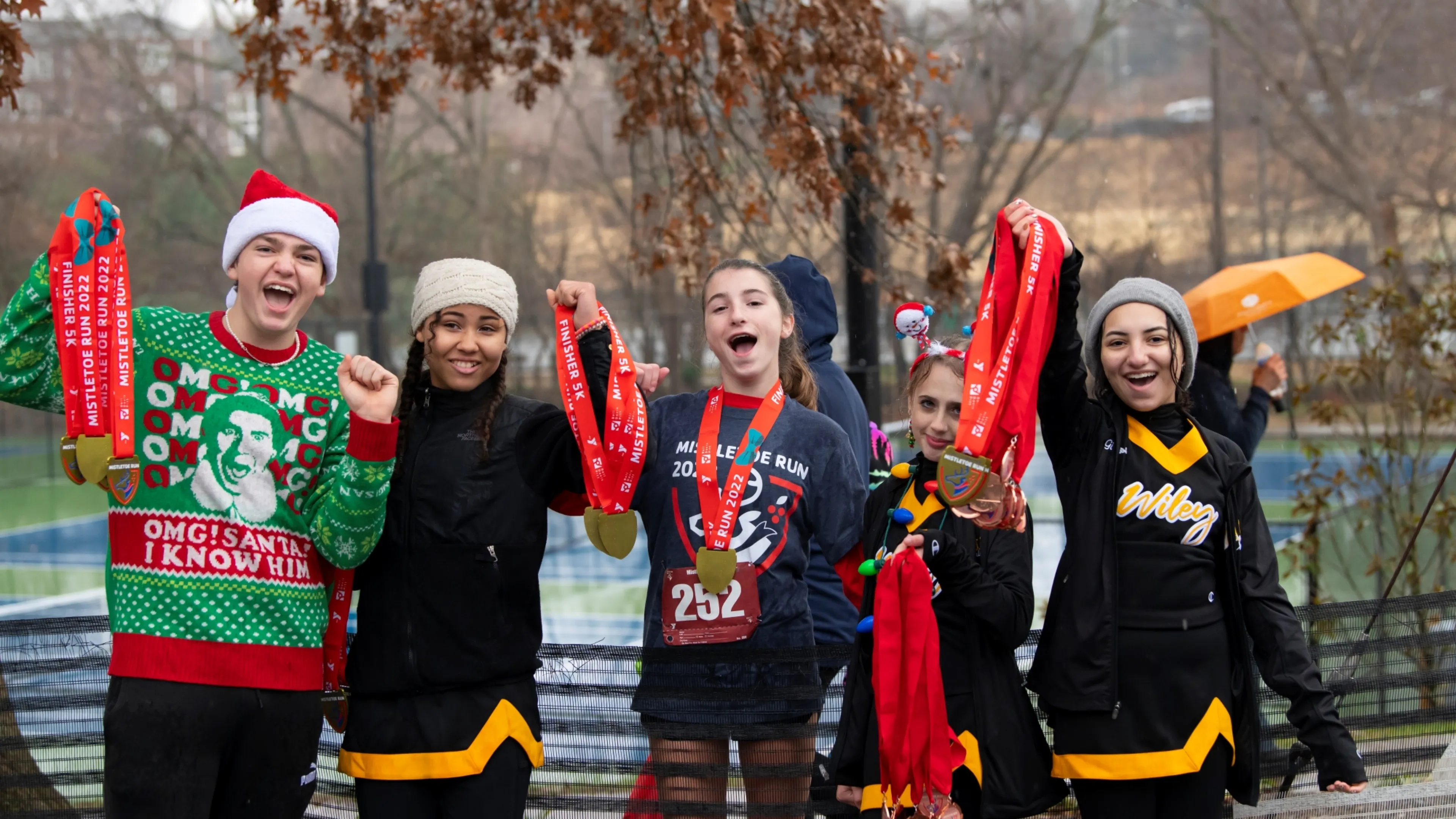 Girls holding up race medals