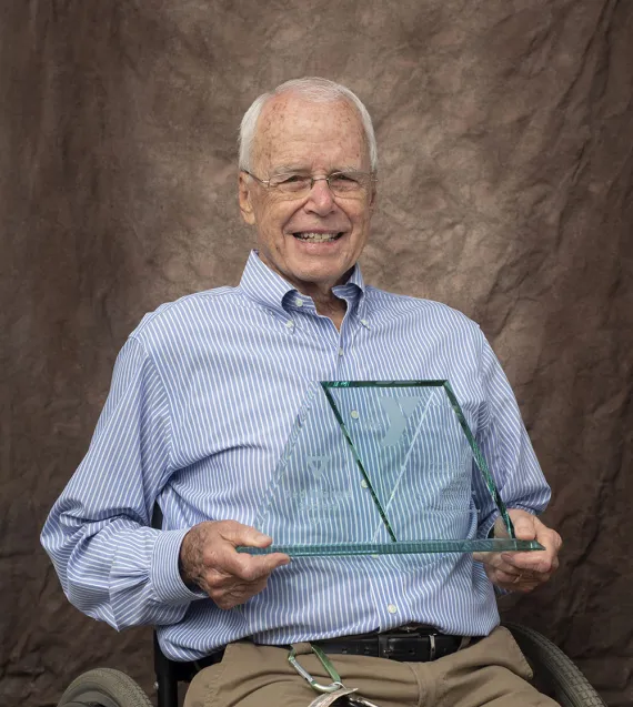 Darle Shouse holding his Red Triangle award