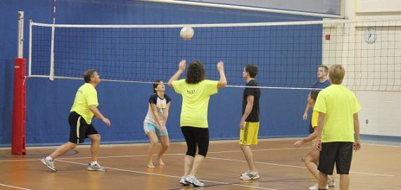 Adult playing volleyball