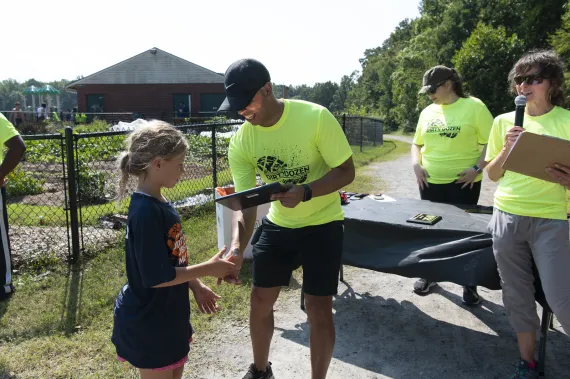 Man checking in a child for a race