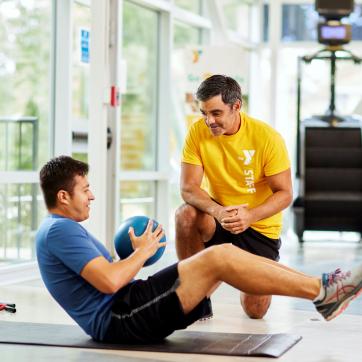 Man working out with trainer
