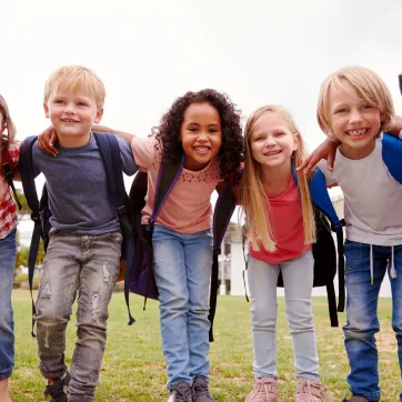 Young kids wearing backpacks