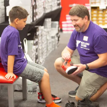 Boy trying on new shoes