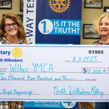 Caroline Whitson and Jenny Richardson presenting check