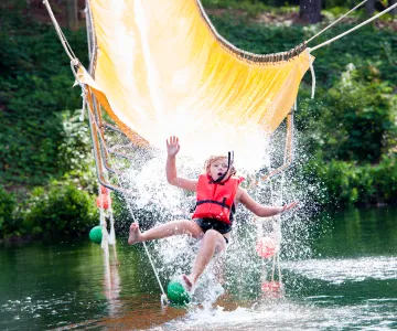 Child on Camp Hanes water zip line