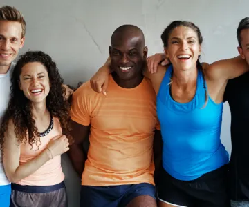 People smiling with their arms around each other