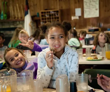Girls eating cookies at Camp Hanes winter camp