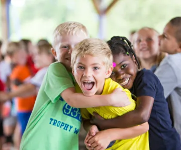 Kids hugging at summer camp
