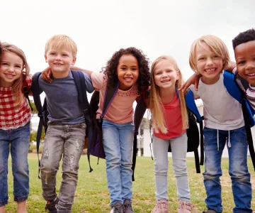 Young kids wearing backpacks