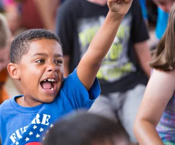 Child happy with his arm in the air