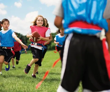 Girls and boys playing flag football
