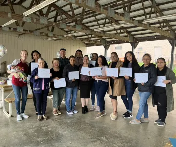 Group of adults holding certificates