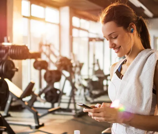 Woman looking at her phone at the gym