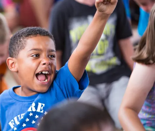 Child happy with his arm in the air