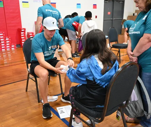 Child being fitted for a new shoe