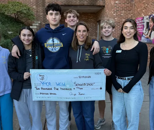 Stroll into Light presenting check to WGW