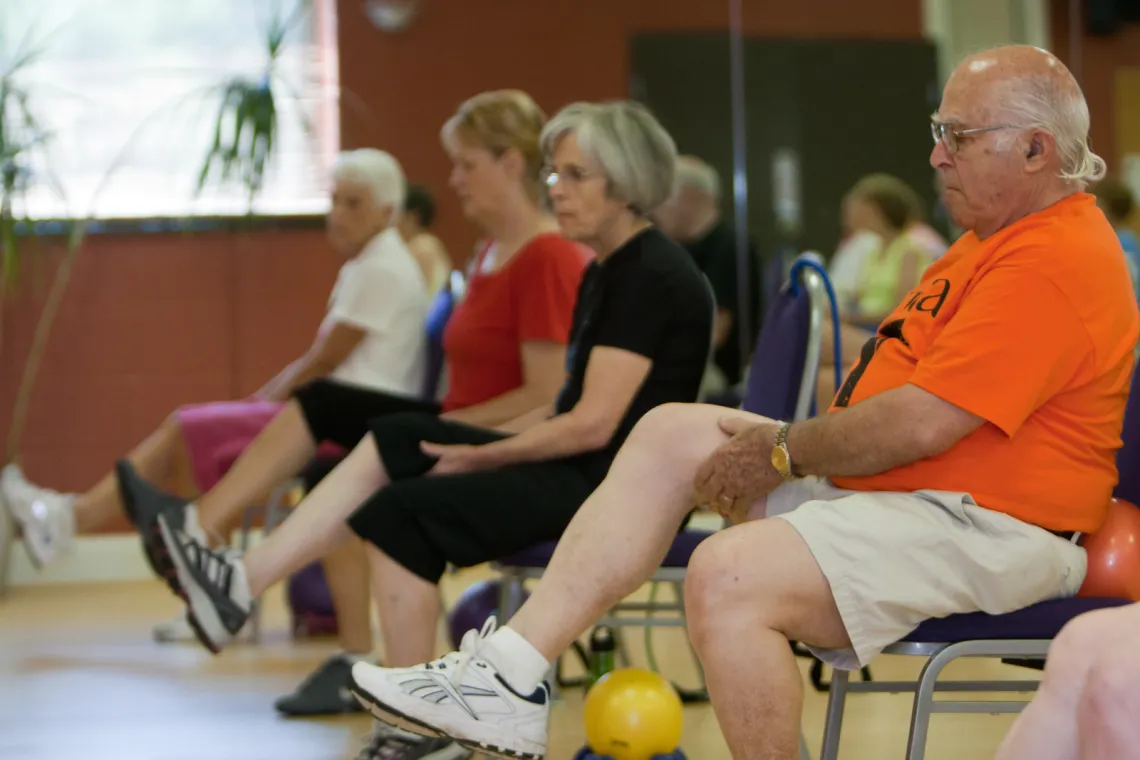 Active older adults doing chair exersizes