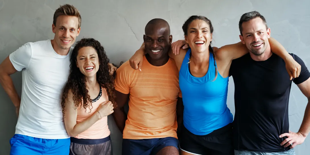 People smiling with their arms around each other