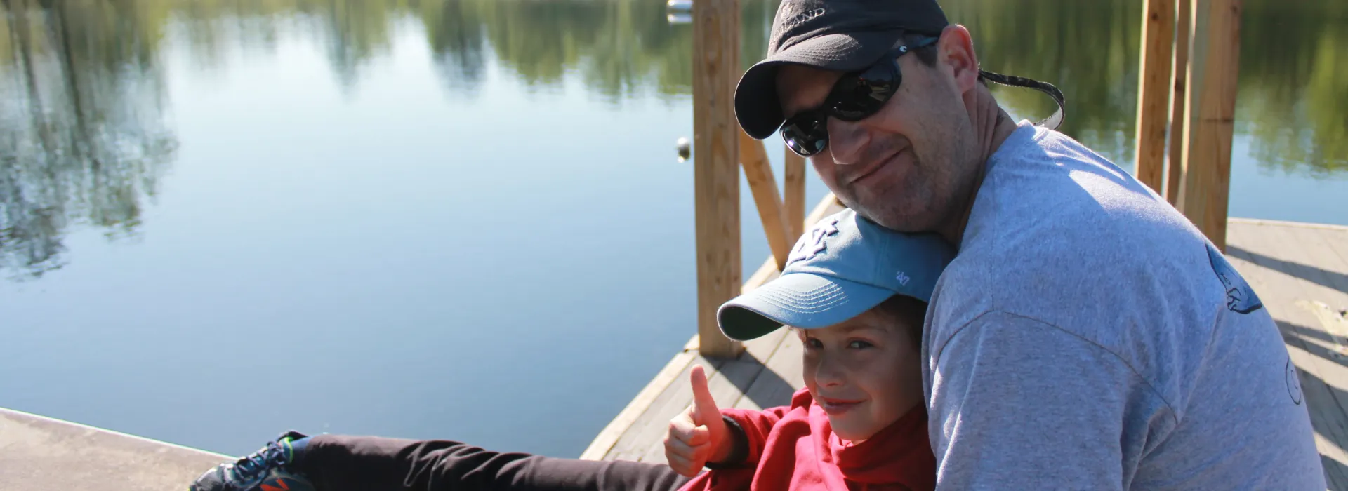 Father and son sitting on a dock