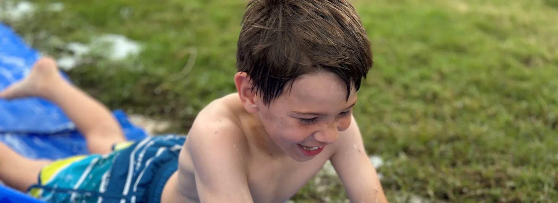 Boy on slip n slide