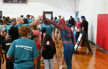 spiderman high fiving a volunteer over a child at Kernersville Bright Beginnings