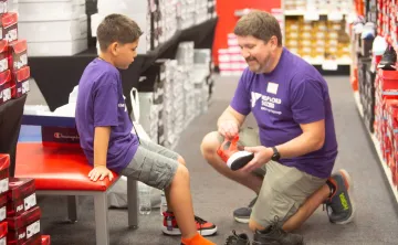 Boy trying on new shoes