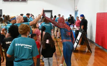 spiderman high fiving a volunteer over a child at Kernersville Bright Beginnings